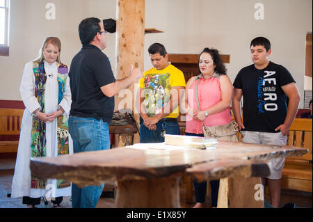 Tucson, Arizona, USA. 10th June, 2014. DANIEL NEYOY RUIZ, a Mexican national living, working and paying taxes in the U.S. since 2005, left (yellow shirt), was granted a stay on his deportation order by Immigration and Customs Enforcement, allowing him to leave the Tucson, Ariz. church where he and his family have taken sanctuary for nearly a month. Aslo pictured are his wife KARLA RUIZ, center, and his son CARLOS RUIZ, right. Ruiz's stay is valid for a year, and his attorney remains hopeful that he'll be eligible for renewal - or that the government will create a path to Stock Photo