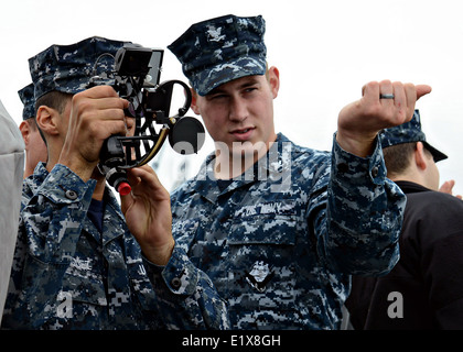 US sailors use a navigational sextant to read the ship's bearings and distance during training June 9, 2014 in San Diego, California. Stock Photo