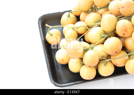 Baccaurea ramiflora or burmese grapes in black dish on white background. Stock Photo