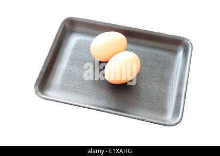 eggs in black tray container isolated on white background. Stock Photo