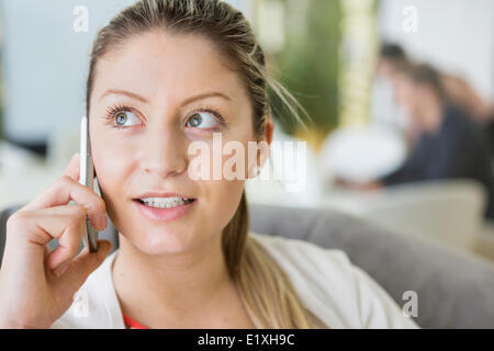 Young businesswoman talking on cell phone in office Stock Photo