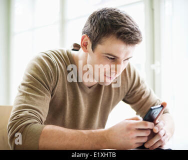 Handsome businessman using cell phone in office Stock Photo