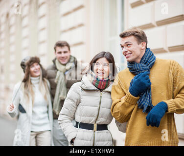 Happy young couples in warm clothing enjoying vacation Stock Photo