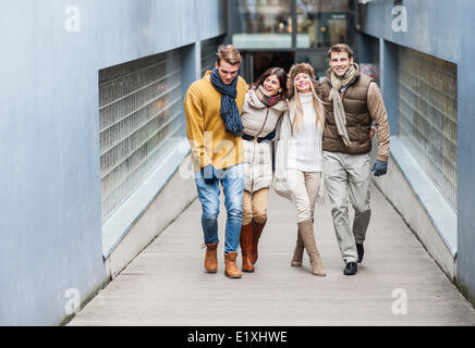Full length of young friends on walkway Stock Photo