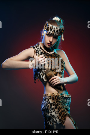 Girl in clothes Amazons with a knife in his hand. Studio photography. Stock Photo