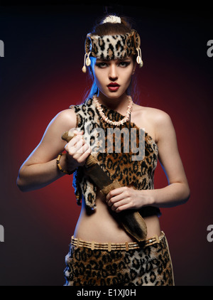 Girl in clothes Amazons with a knife in his hand. Studio photography. Stock Photo