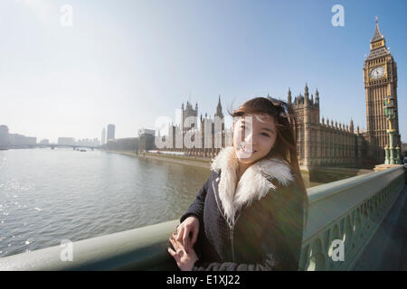 Portrait of happy female tourist visiting Big Ben at London, England, UK Stock Photo