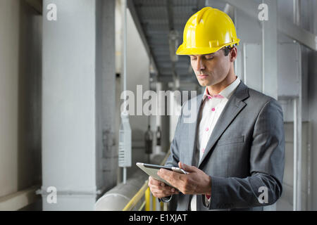 Young male architect using tablet computer in industry Stock Photo