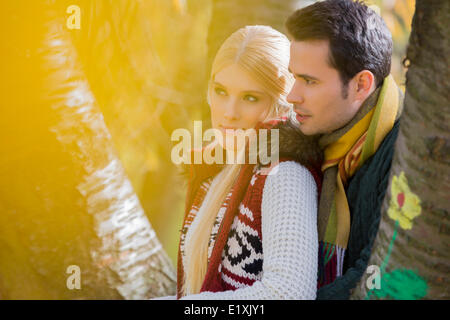 Thoughtful loving couple looking away in park Stock Photo