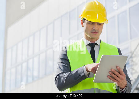 Young male engineer using digital tablet outside industry Stock Photo