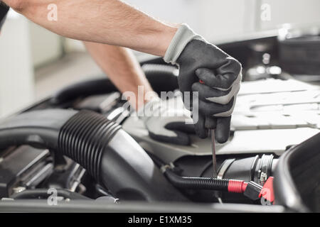 Cropped image of automobile mechanic repairing car in automobile store Stock Photo