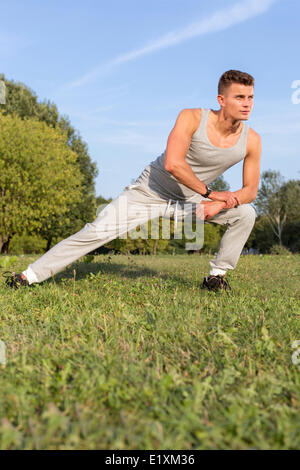 Full length of determined man exercising in park Stock Photo