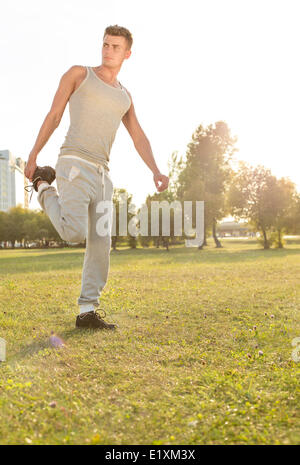 Full length of young man exercising in park Stock Photo