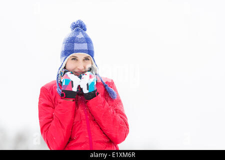 Beautiful young woman in warm clothing walking outdoors Stock Photo