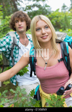 Hiking, binoculars and love with a couple on a mountain, enjoying a