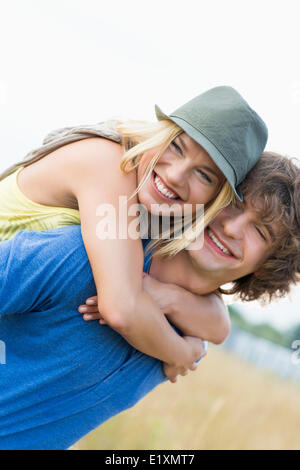 Happy young couple enjoying in field Stock Photo