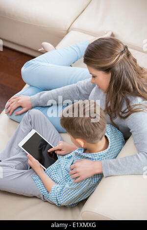 High angle view of mother and son using tablet PC on sofa Stock Photo