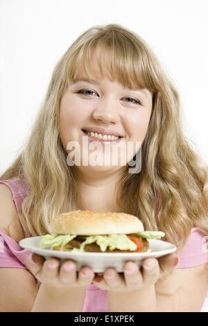 The young girl with a hamburger Stock Photo