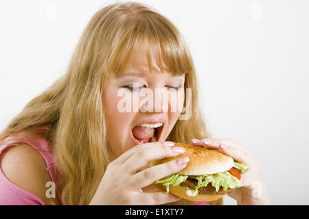 Hungry blonde and hamburger Stock Photo