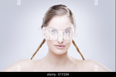 Woman wearing plastic protective goggles. Stock Photo