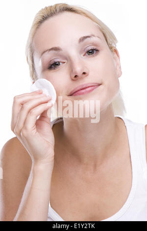 Beautiful blonde removing facial make-up Stock Photo