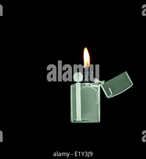 Zippo lighter x-ray with a transparent body revealing internal components and a classic wick, flint, and fuel mechanism, casting bright burning flame Stock Photo