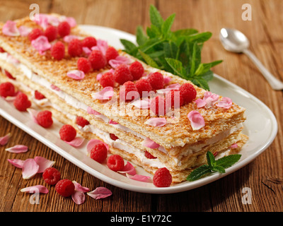 Millefeuille with raspberries and roses. Recipe available. Stock Photo