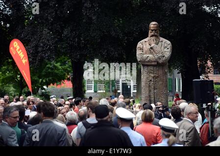 Wuppertal, Germany. 11th June, 2014. People take part in the unveiling of the monument of the philosopher and social theorist Friedrich Engels (1820-1895) donated by the People's Republic of China in Wuppertal, Germany, 11 June 2014. The nearly four-meter bronze sculpture commemorates the co-founder of Marxism, who was born in Wuppertal. Credit:  dpa picture alliance/Alamy Live News Stock Photo