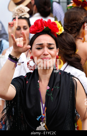 Spanish women wearing gypsy flamenco costume and dancing at El Rocio Stock Photo