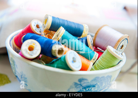 Cotton Reels and Needles in a bowl Stock Photo