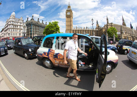 Whitehall, London, UK. 11th June 2014.  Drivers of London black cabs (pictured) Jay Izzet from East London, bring traffic to a standstill in the area around Trafalgar Square, the Houses of Parliament and government buildings on Whitehall in a protest against the Uber app-based service Credit:  Clickpics/Alamy Live News Stock Photo