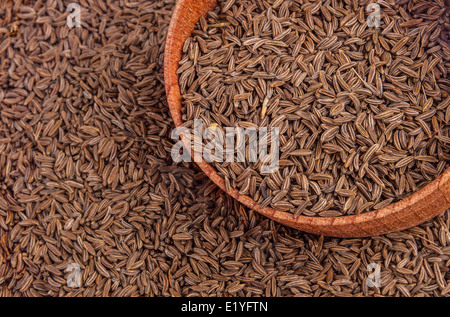 Cumin seeds in a wooden plate Stock Photo