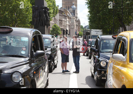 Whitehall, London, UK. 11th June 2014.  Drivers of London black cabs bring traffic to a standstill in the area around Trafalgar Square, the Houses of Parliament and government buildings on Whitehall in a protest against the Uber app-based service Credit:  Clickpics/Alamy Live News Stock Photo
