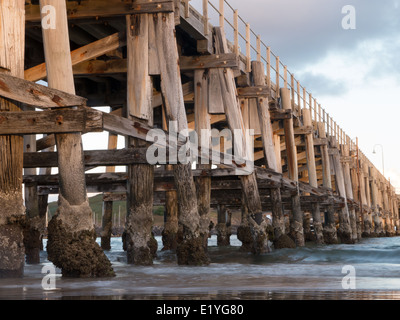 Wood bridge extending to the ocean Stock Photo