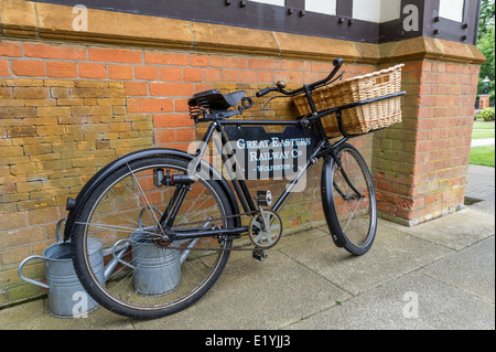 Black cycle with wicker carrying basket  the Great Eastern railway company at Wolferton station in Norfolk, England. Stock Photo
