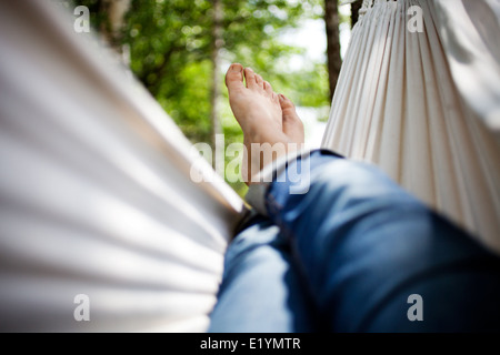 Woman relaxing in hammock Stock Photo