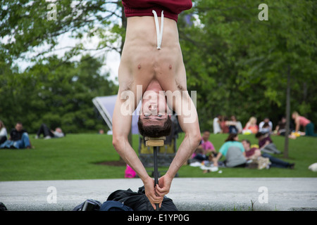 Acrobats practice their strength hand balancing act in Jubillee Gardens. South Bank, London, UK. Stock Photo