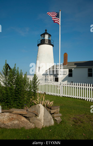Pemaquid Point lighthouse and adjoining Fisherman's Museum, which was once the keeper's quarters. American flag waves above the beacon. Stock Photo