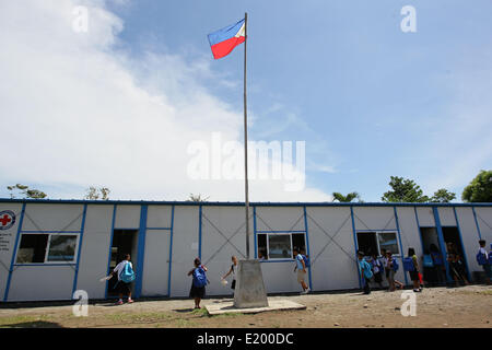 Tacloban City, Philippines. 11th June, 2014. Students walk their way through their school in San Jose Central School, Tacloban City. On November 8, 2013, Haiyan, one of the most powerful typhoon to ever hit land, ravaged Eastern Visayas leaving thousands dead and homeless. Government estimates 16 million people to have been affected by the typhoon, with 6,300 reported dead and thousands more missing. Credit:  PACIFIC PRESS/Alamy Live News Stock Photo