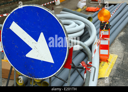 big blue sign with white arrow during excavation work on the street in the city Stock Photo