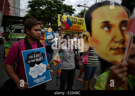 Makati, Philippines. 12th June, 2014. Demonstrators hold a protest a protest outside the Chinese consulate in Makati, Metro Manila, Philippines, June 12, 2014. Demonstrators marked Independence Day in the Philippines by holding a protest versus China's alleged bullying over a territorial dispute with the Philippines and Vietnam in the South China Sea.Photo: Ezra Acayan/NurPhoto Credit:  Ezra Acayan/NurPhoto/ZUMAPRESS.com/Alamy Live News Stock Photo