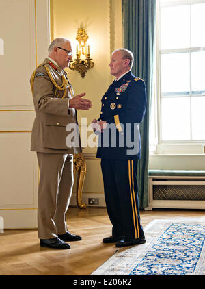 US Chairman of the Joint Chiefs Gen. Martin Dempsey, talks with U.K. Chief of General Staff Gen. Sir Peter Wall before a meeting with U.K. Prime Minister David Cameron as a part of a Defense Chiefs Strategic Dialog Group with US and UK defense chiefs June 10, 2014 in London, UK. Stock Photo