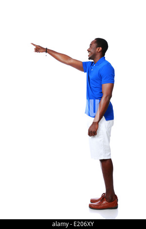 Side view portrait of happy african man pointing at something over white background Stock Photo