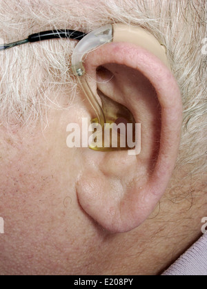 Elderly man wearing a digital hearing aid Stock Photo