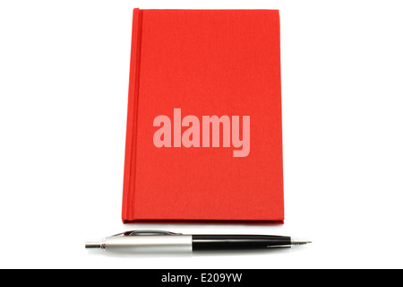 Red notepad with ball pen on a white background Stock Photo