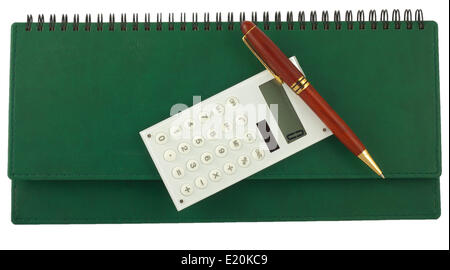 Pen and calculator on green organizer Stock Photo