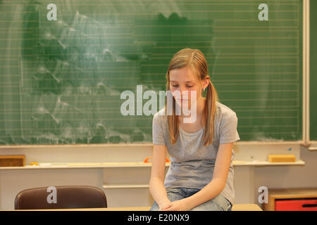 Sad blonde girl in school Stock Photo