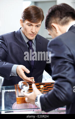 Two successful businessmen play a chessboard Stock Photo