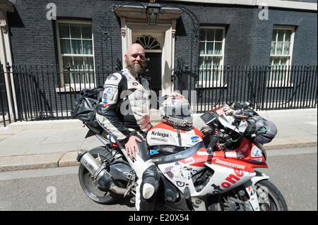 Whitehall, London, UK. 12th June 2014. Since October 2012 Bruce Smart has been riding a Suzuki GSX-R1000 around the world in an attempt to raise awareness and £70K for 5 charities: The St Christopher’s Hospice, The Children’s Trust, The Lymphoma Association, Born Free Foundation, and The Royal British Legion. Today Bruce completed his mammoth test of endurance, finally reaching his destination at 10 Downing Street, London. Stock Photo