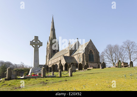 The war memorial and St. Peter's ,the parish church of Belmont, Lancashire. A typical Victorian church built in neo-gothic style Stock Photo